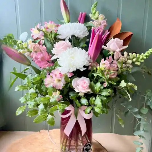 Big and tall vase full of pink and white flowers