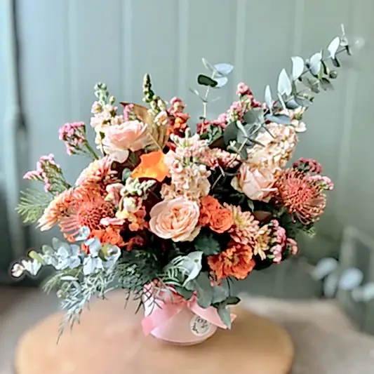 mixed peach flowers in a pot