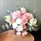 Pink and white tonal flowers arranged in a hatbox