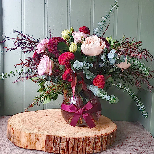 romantic flowers in fishbowl vase