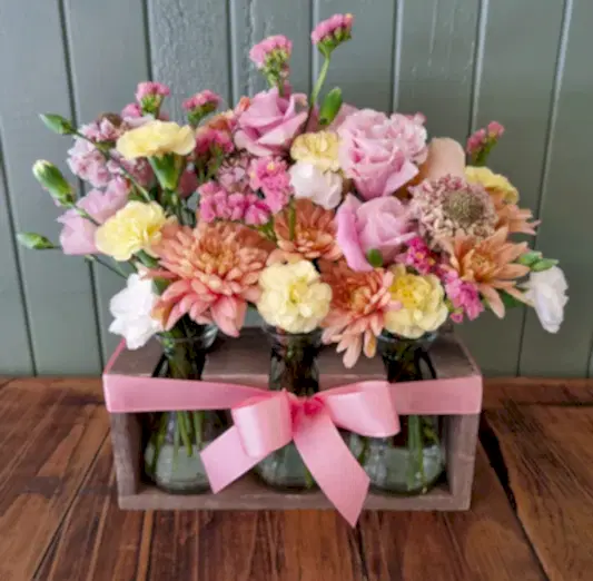 Trio of vases and stand full of seasonal flowers