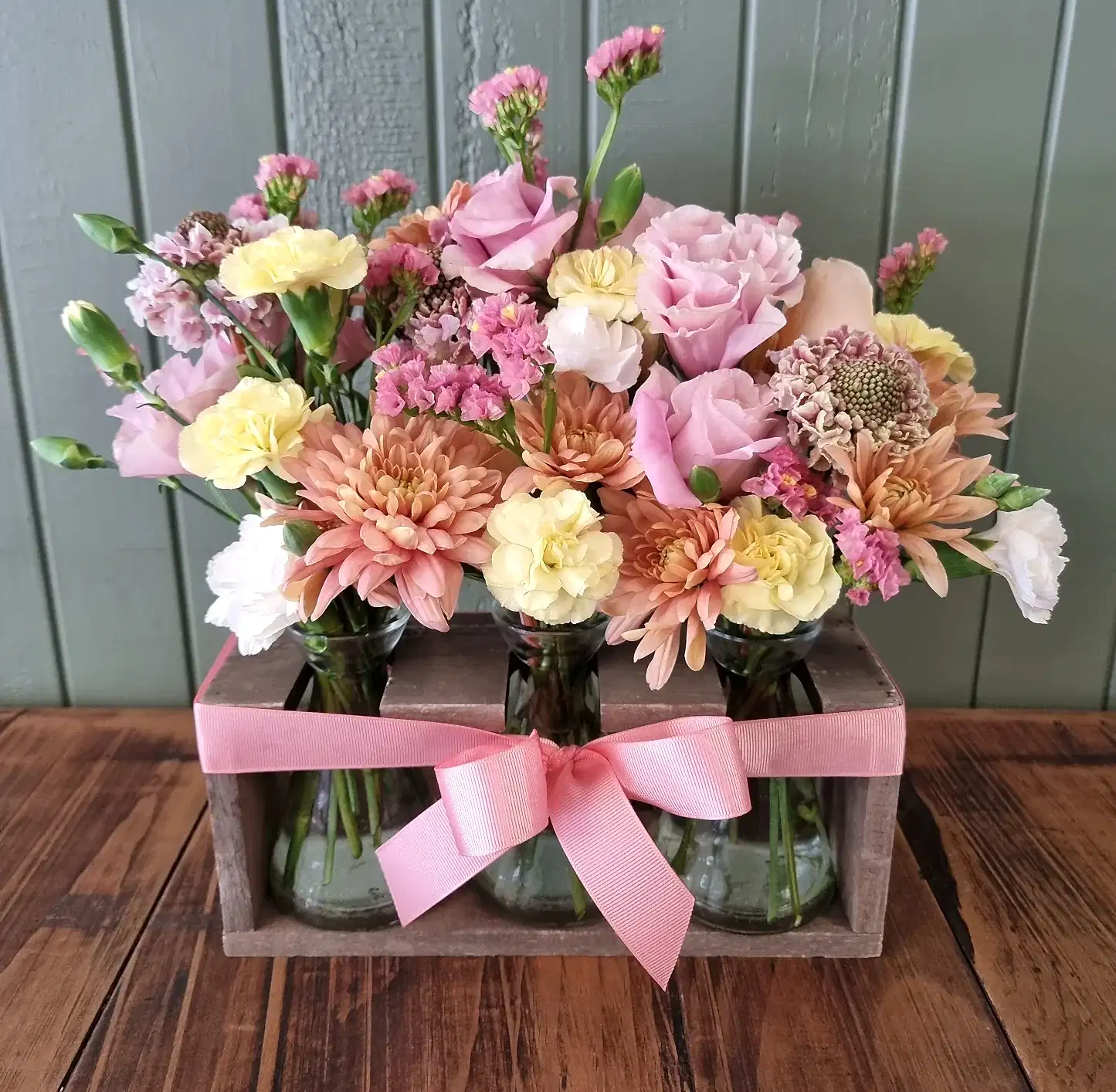 Trio of vases and stand full of seasonal flowers